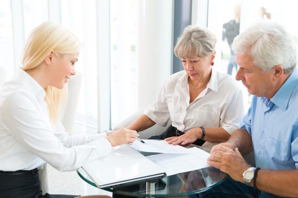 A care professional reviewing assessment results with an older couple